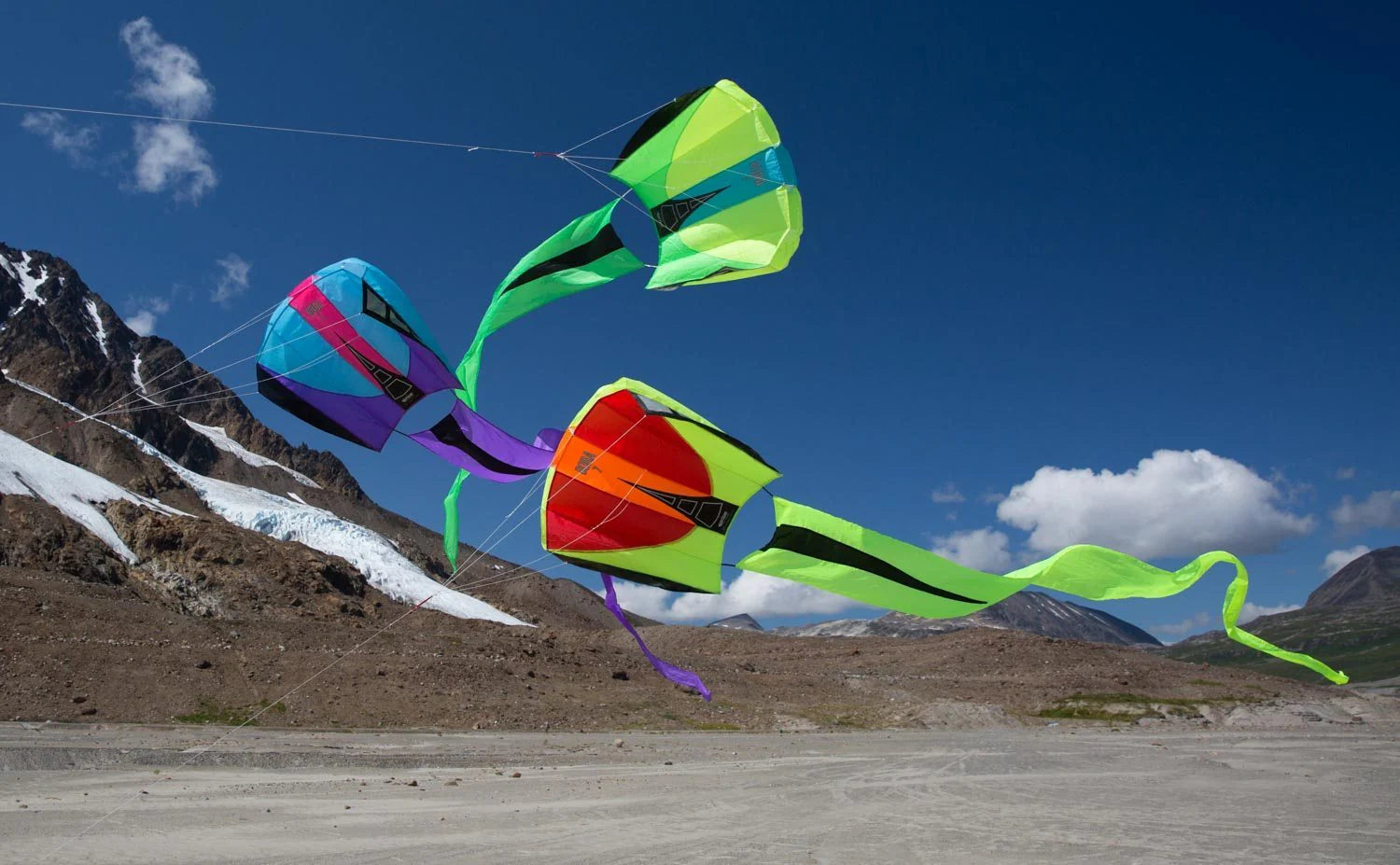Compact parafoil kite with a flowing 16-foot tail, frameless construction, and ready-to-fly design for portable outdoor adventures.