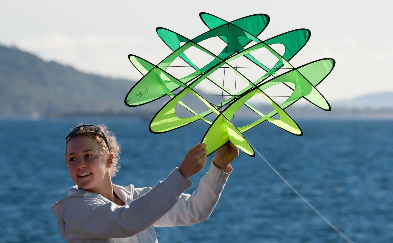 Pop-up box kite with stable multi-cell design, playful trick-flying capabilities, and no-assembly convenience for easy outdoor fun.