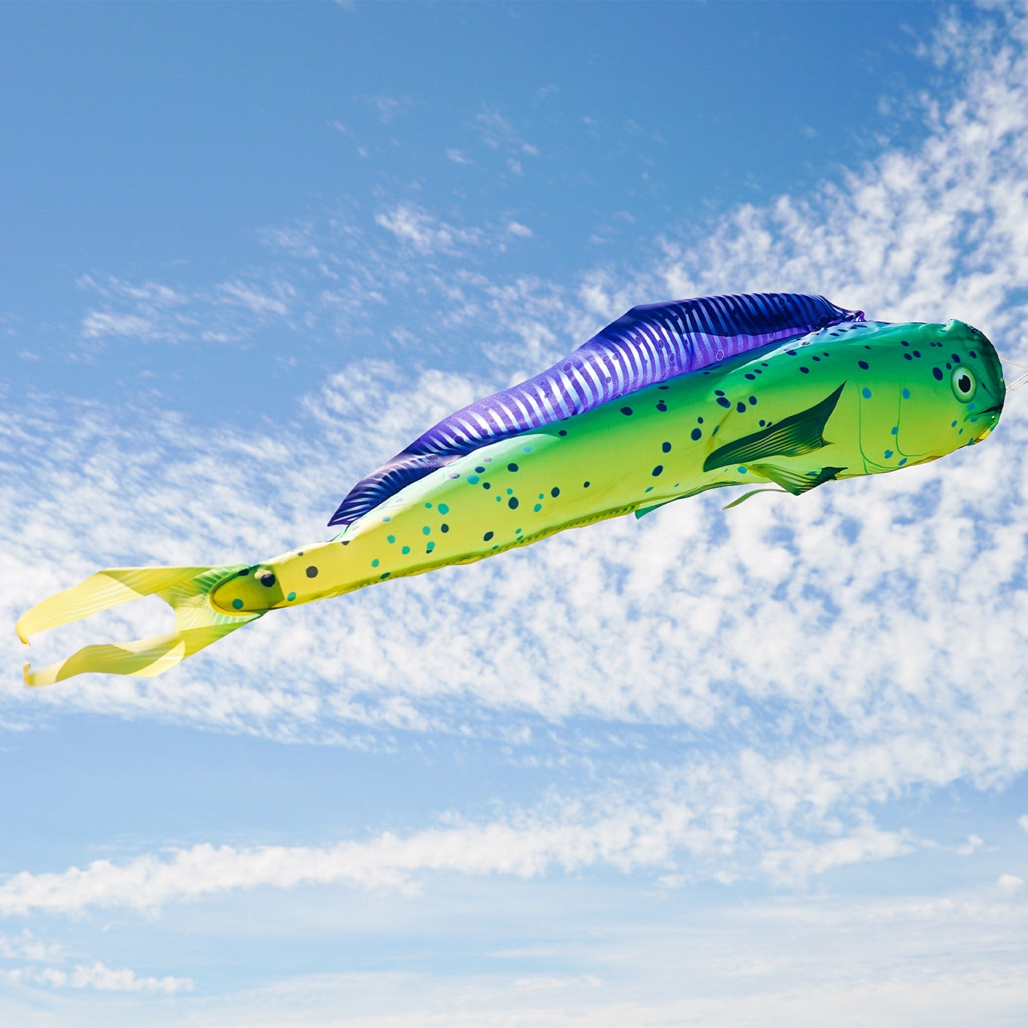 Dorado 48-Inch Fish Windsock with a colorful fish design displayed outdoors fluttering in the breeze near a boat dock.