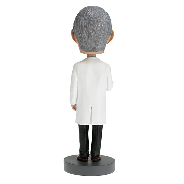 Dr. Anthony Fauci Bobblehead, over 8 inches tall, featuring detailed likeness, displayed on a desk with a vibrant box in the background.