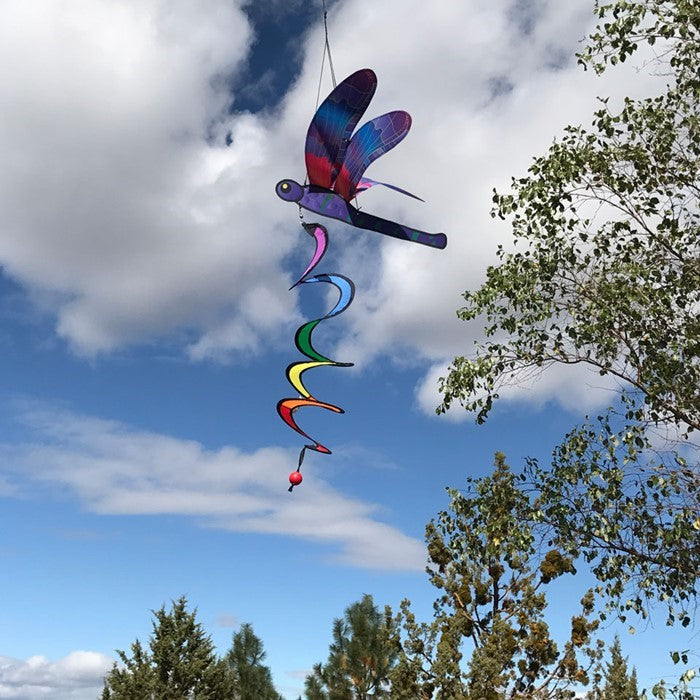 Dragonfly Theme Twister featuring moveable wings and vivid colors, charmingly spinning in a garden setting.