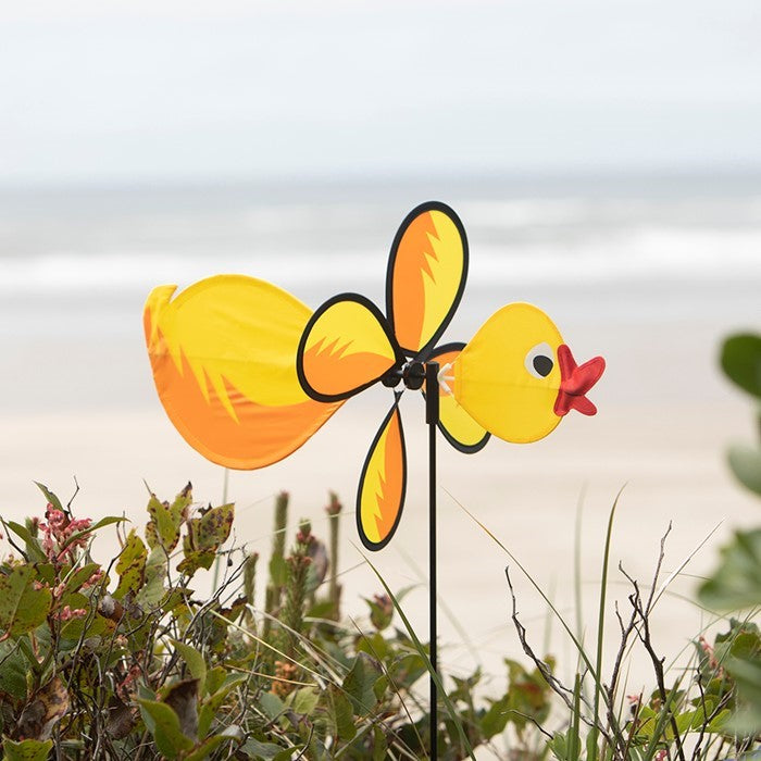 Duck Baby Spinner with bright colors and a 12-inch wheel displaying in a garden, featuring a baby duck design and fiberglass pole.
