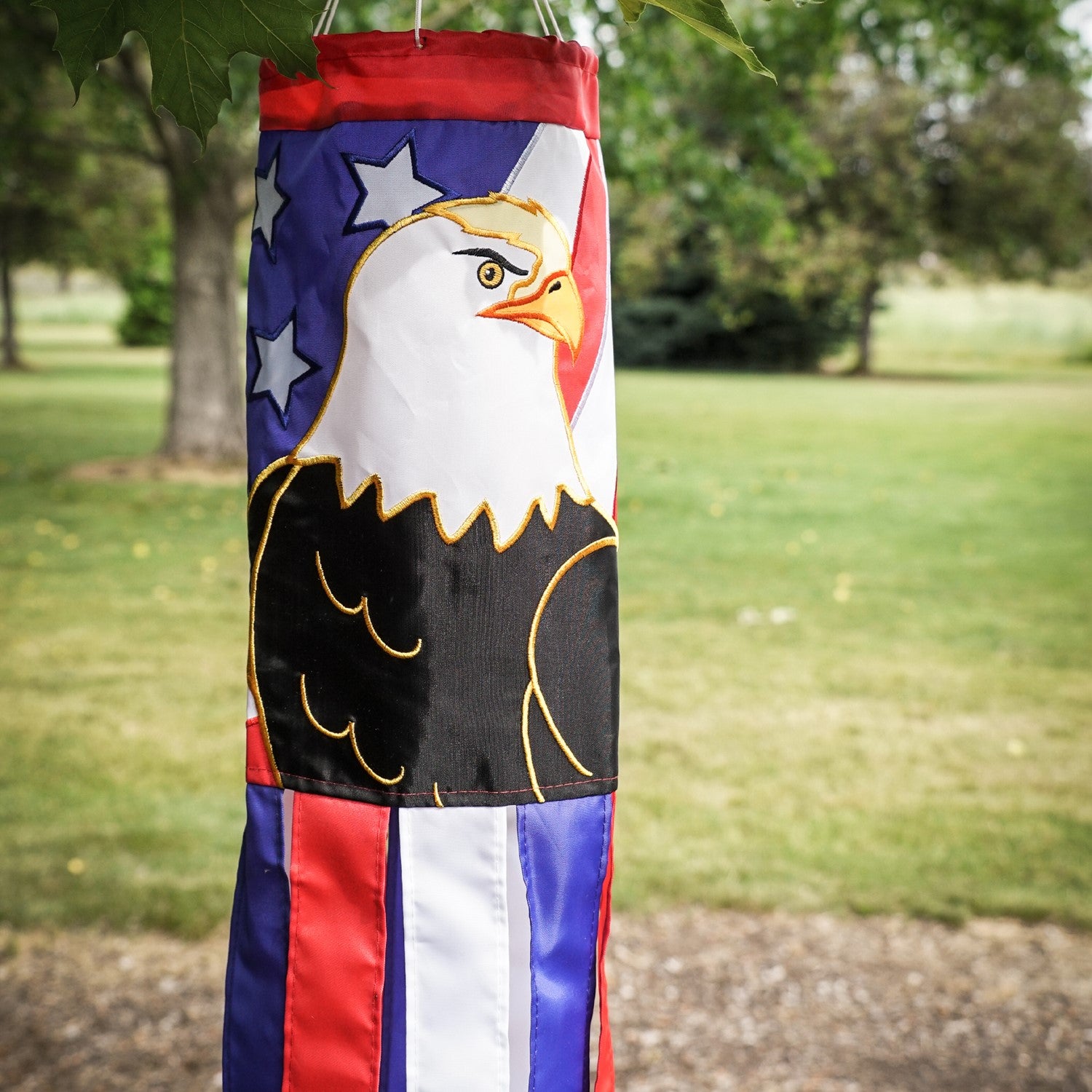 Eagle 40-inch windsock displaying vibrant red, white, and blue colors with applique design and coordinating tails fluttering in the breeze.