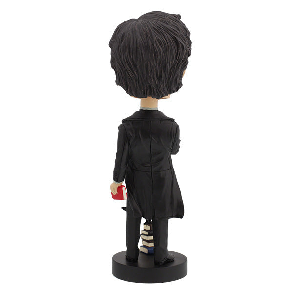 Edgar Allan Poe bobblehead standing 7 inches tall, featuring intricate details and dark attire, displayed on a desk with classic literature in the background.