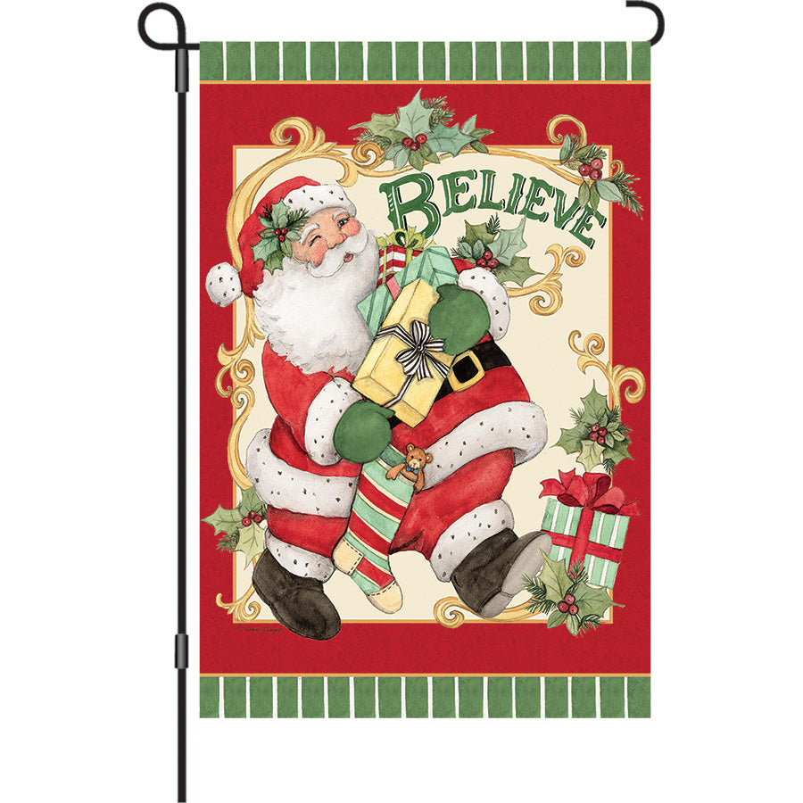 13 in. Elite Oversized Garden Flag displaying a whimsical Retro Santa design, bright colors, and a velvety soft finish in a garden setting.