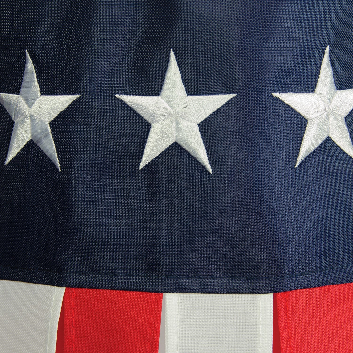 Embroidered Stars & Stripes 33\" windsock displaying vibrant red, white, and blue colors with detailed embroidered stars, hanging outdoors.