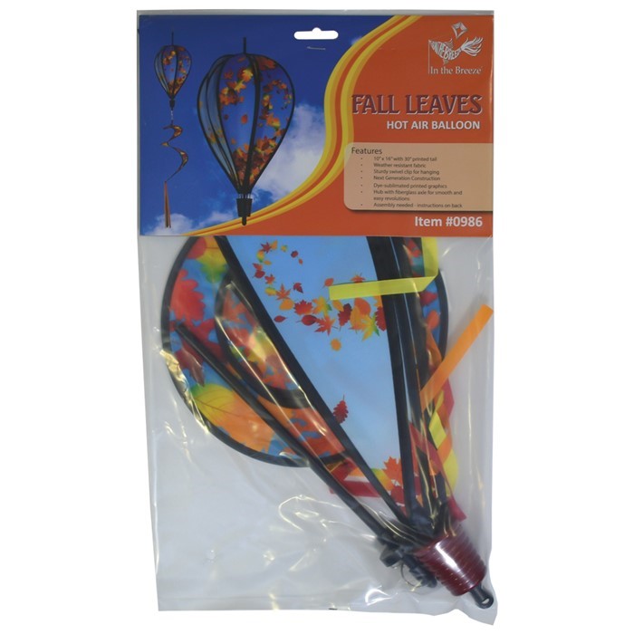 Colorful 6-panel hot air balloon spinner featuring falling autumn leaves, suspended in an outdoor garden setting, capturing the essence of fall.