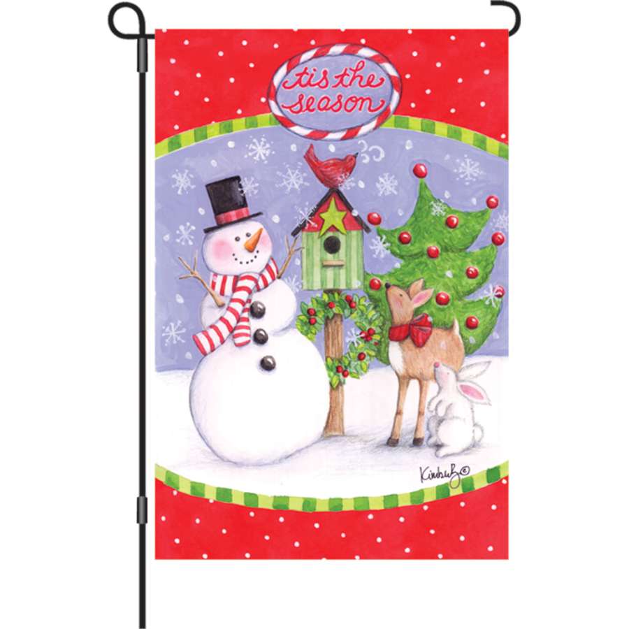 12 in. Festive Friends garden flag made from PremierSoft fabric, displaying the cheerful message 'tis the season' in vibrant colors on a garden pole.
