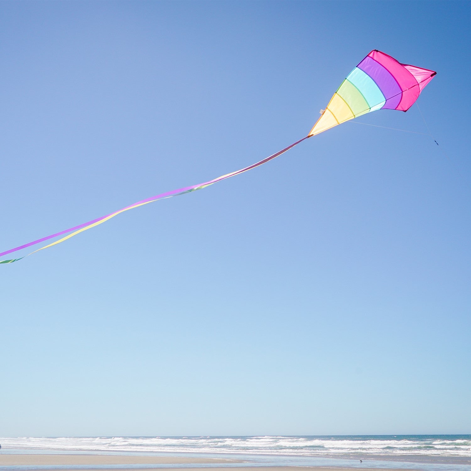 Fiesta Arch 39" Diamond Kite with colorful design flying high against a bright blue sky during outdoor family fun.