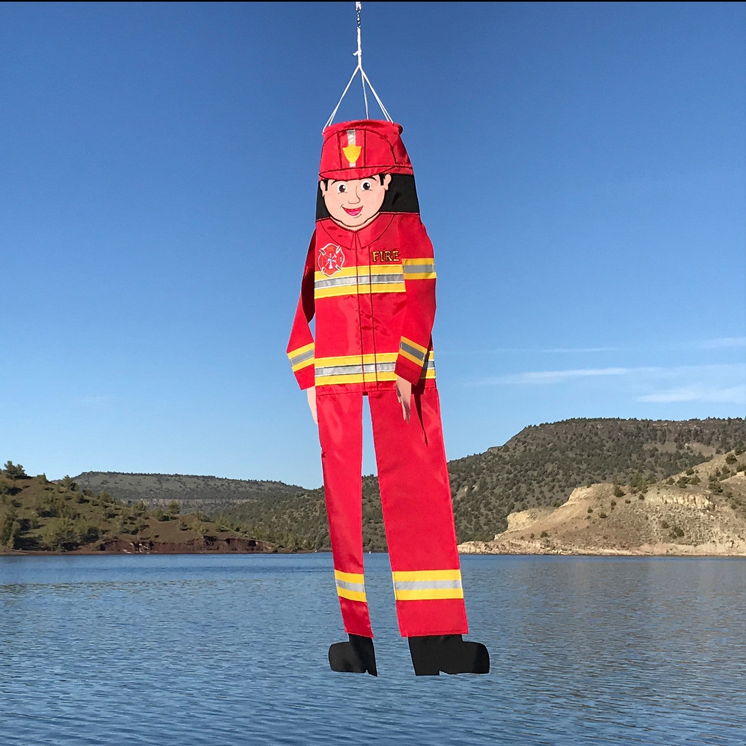 Firefighter 40-inch Breeze Buddy windsock with colorful design and flowing limbs, displayed in a garden setting, showcasing firefighter pride.