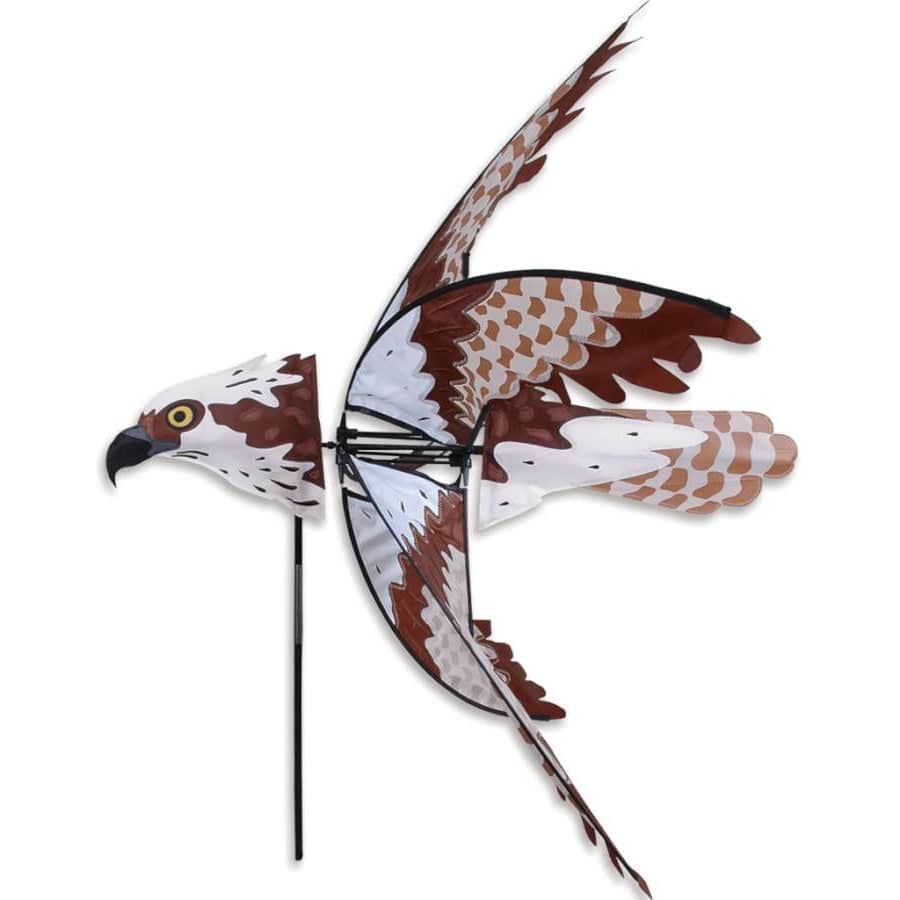 Graceful osprey garden spinner with wide wingspan, natural brown coloring, and smooth wind-powered rotation for outdoor coastal displays.