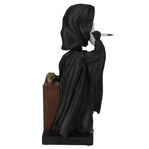 Ghost Face Bobblescape Bobblehead depicting Ghost Face with a bloodied knife, accompanied by a vintage tube TV displaying "Ghost Face Lives" for horror fans.