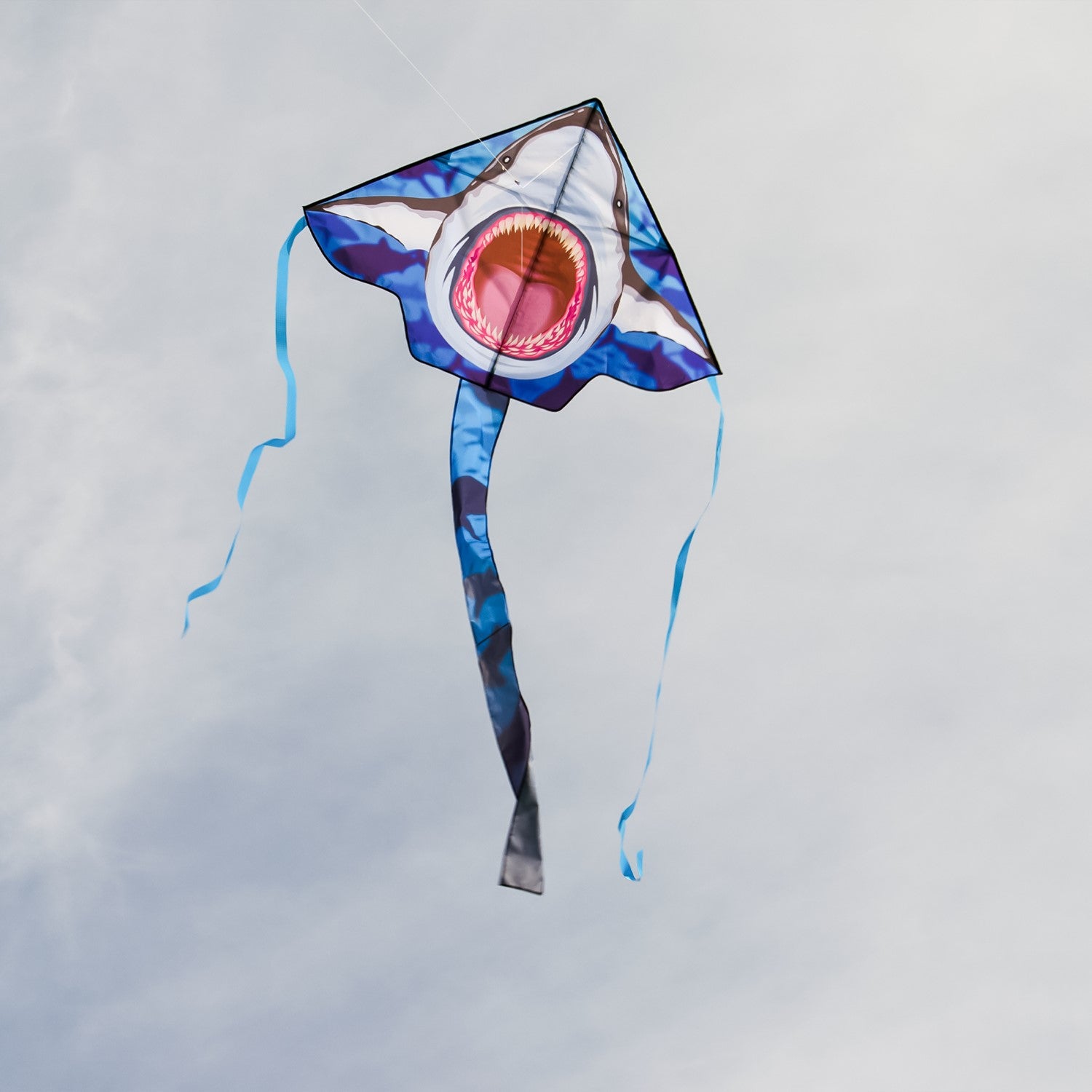 Great White 45' Fly-Hi Kite with a vibrant shark design flying against a blue sky, perfect for outdoor family fun and novice fliers.