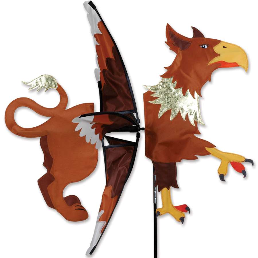 Griffin Spinner outdoor kinetic sculpture in vibrant colors spinning gently in a garden, showcasing its mythical griffin design.