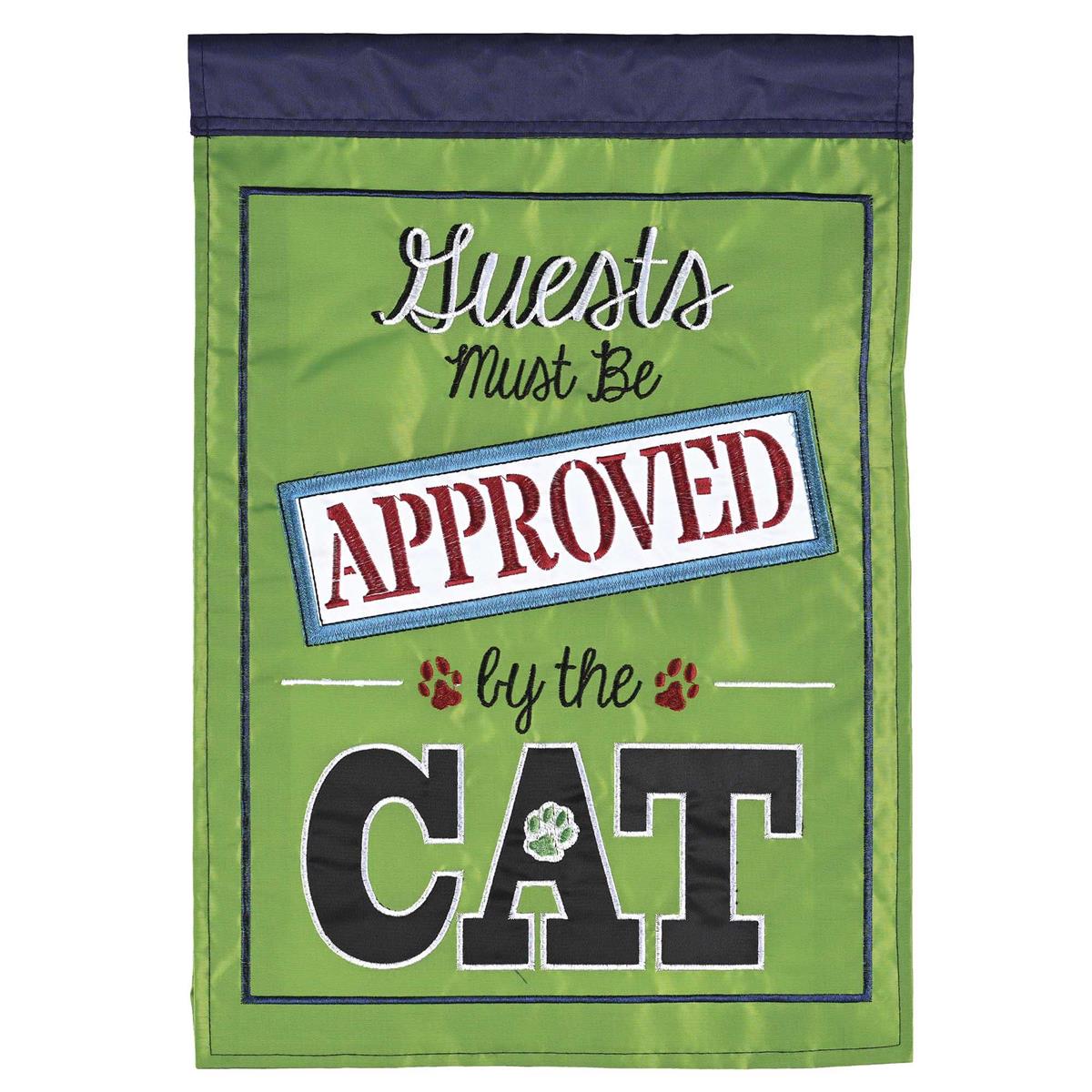 Guest Must Be Approved By Cat double-sided garden flag with playful cat design displayed in an outdoor garden setting, featuring bright colors and intricate embroidery.