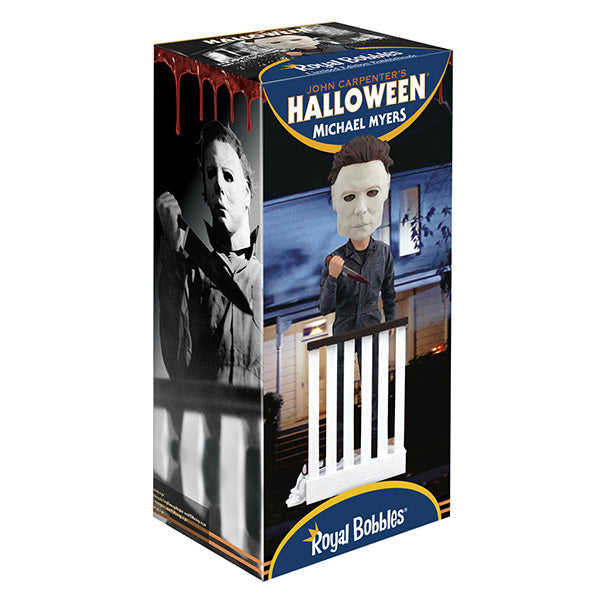 Halloween Michael Myers Bobblehead leaning over a stair railing, with a ghost sheet and glasses at his feet, capturing the essence of classic horror.