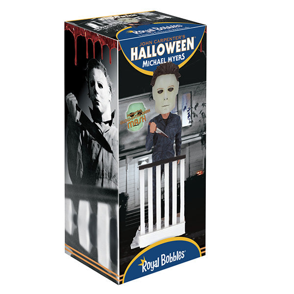 Halloween Michael Myers Glow in the Dark Mask Bobblehead leaning over a ghost-sheet prop with Bob's glasses, capturing slasher theme decor.