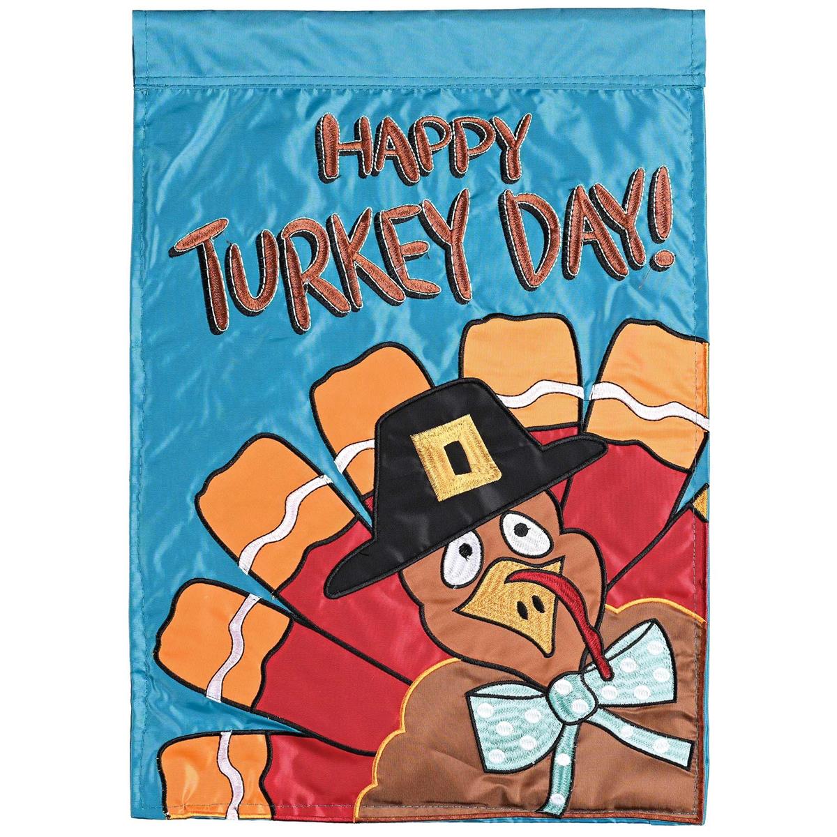 Happy Turkey Day double-sided garden flag featuring a colorful turkey design, displayed outdoors with vibrant autumn foliage in the background.