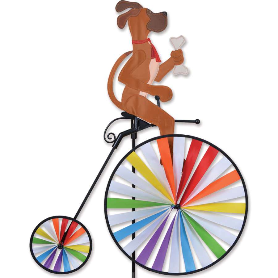 High Wheel Bike Spinner with a classic bicycle design, showcasing vibrant colors, installed in a beautiful garden setting under blue skies.