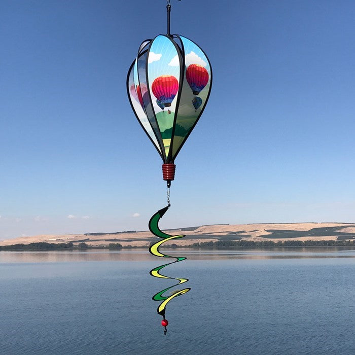 Colorful Hot Air Balloon spinner in vibrant fabric spinning in a garden setting, showcasing unique designs on each panel as it catches the wind.