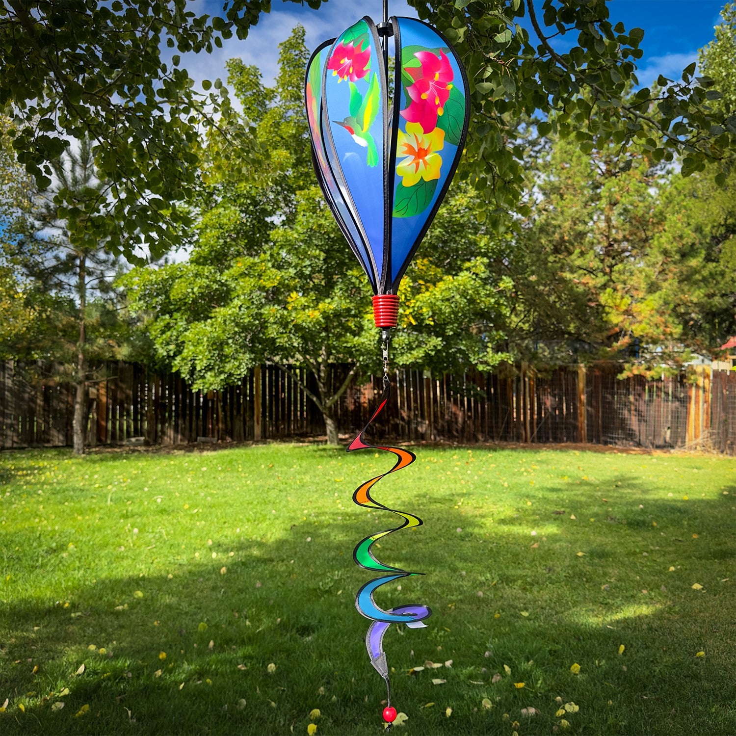 Hummingbird Flowers Hot Air Balloon spinner with colorful flower and hummingbird designs, spinning gracefully in an outdoor setting.