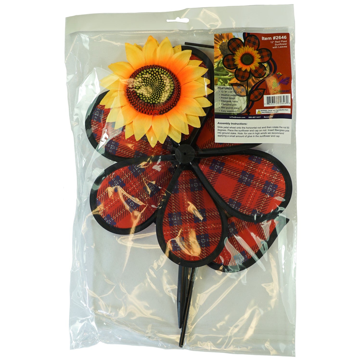 Alt text: "12-inch Red Plaid Flower with Leaves garden spinner featuring vibrant plaid petals and detailed sunflower center, displayed outdoors.