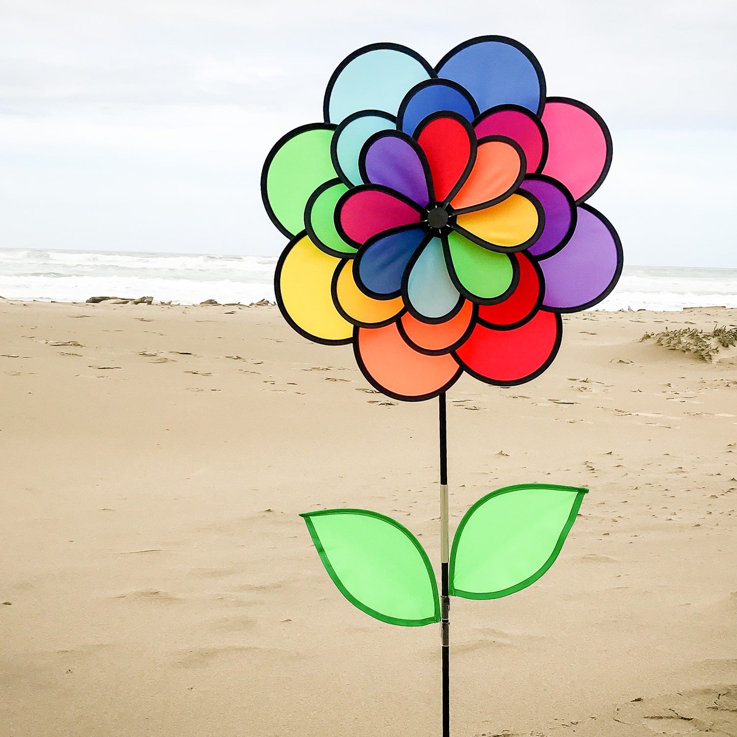 Alt Text: "Vibrant 24 Petal Flower spinning in the garden with colorful petals and leaves attached to a fiberglass stem, showcasing a delightful outdoor decor option.
