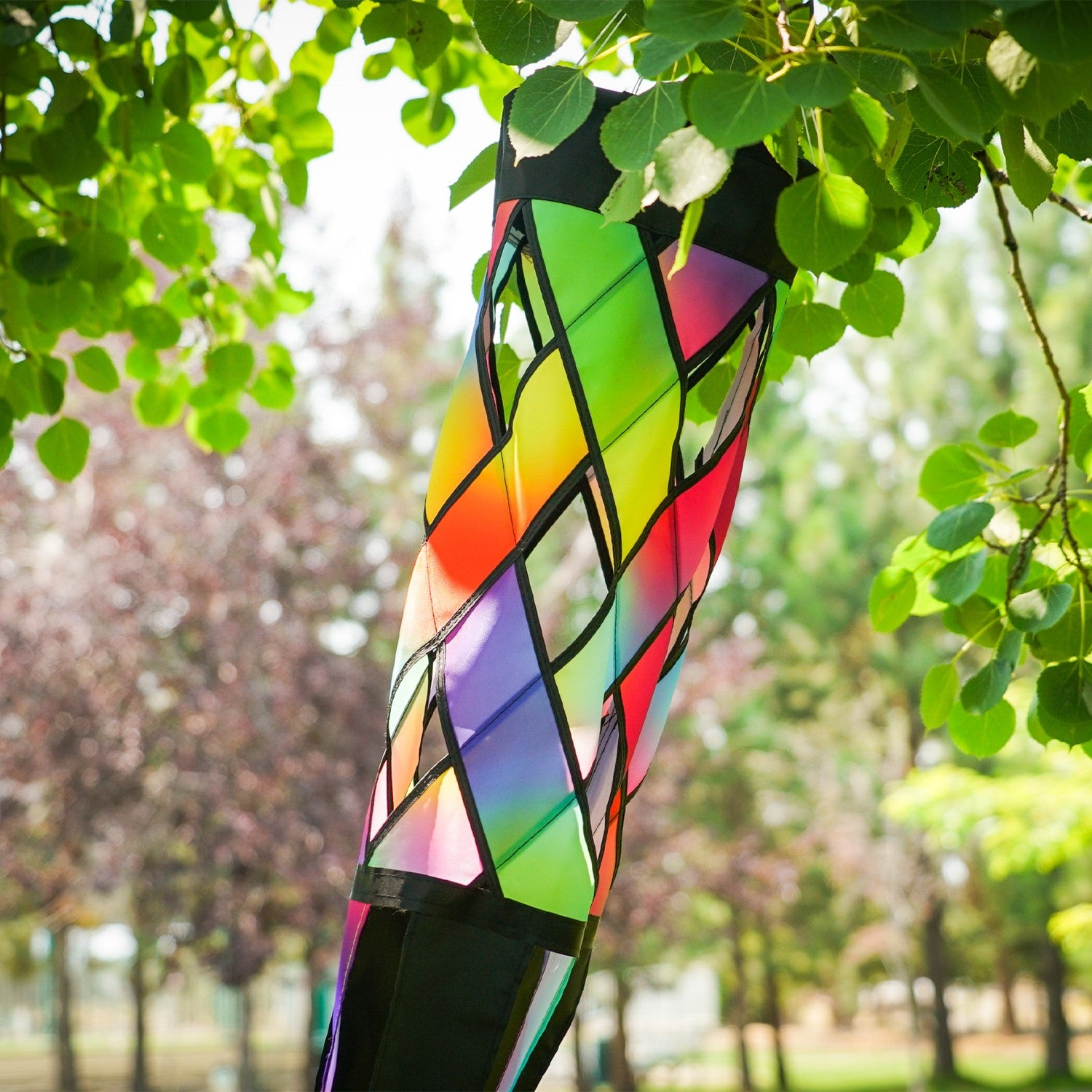Brightly colored Jewel Diagonal Weave 60" Windsock showcasing jewel tones and black tails fluttering in the breeze, perfect for outdoor decor.