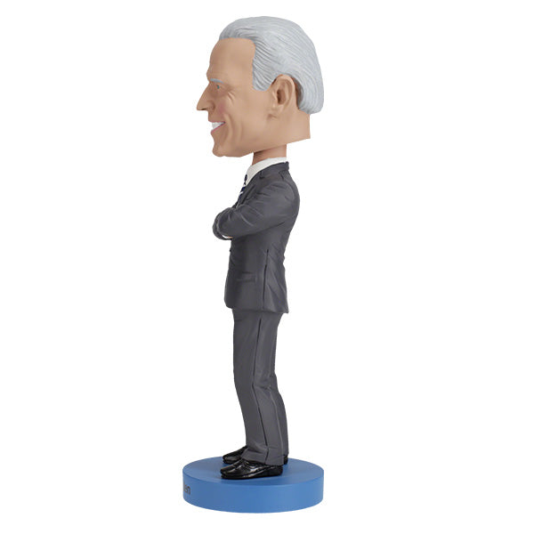 Joe Biden bobblehead standing over 8 inches tall, hand-painted with authentic details, displayed on a colorful shelf against a neutral background.