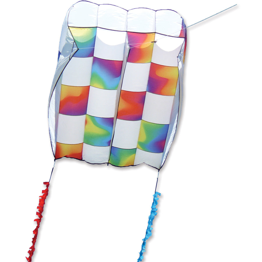 Killip Foil Kite 20 in vibrant rainbow check design flying in the air with a 50 ft. fuzzy tail against a clear blue sky.