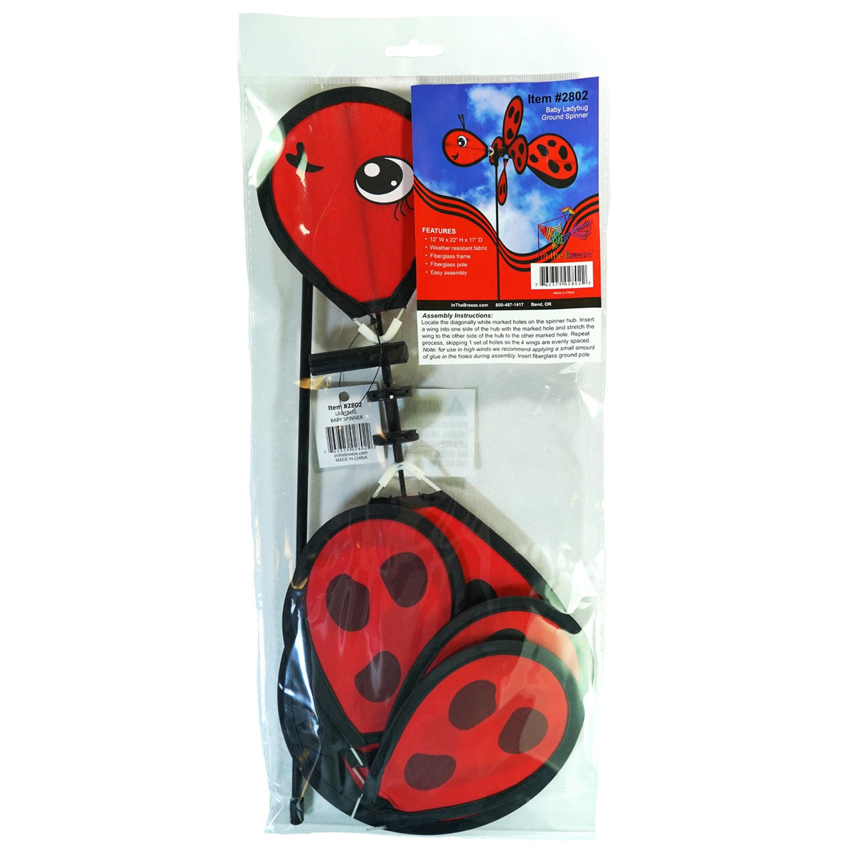 Ladybug Baby Spinner featuring a colorful 12-inch wheel on a sturdy fiberglass pole, designed for lively outdoor decoration in a garden setting.