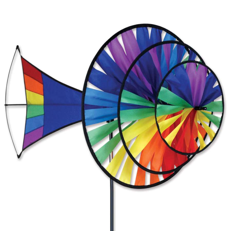 Large Rainbow Triple Spinner featuring three rotating sections in a vibrant gradient displayed in a garden setting on a sunny day.