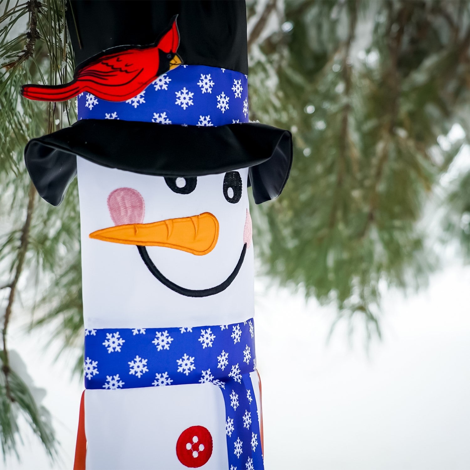 Lil' Snowman 3D 40-inch windsock with a playful snowman design and colorful tails, hanging outdoors in a winter setting.