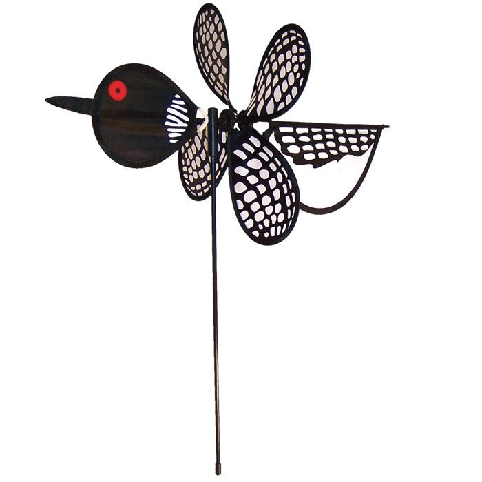 Loon Baby Spinner with colorful baby loons on a 12-inch wheel, spinning gracefully on a 17-inch fiberglass pole in an outdoor garden setting.