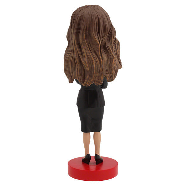 Melania Trump Bobblehead standing 7 inches tall, showcasing intricate details of her elegant attire and signature hairstyle on a display shelf.