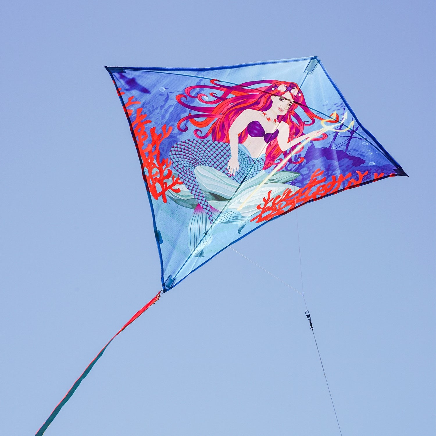 Mermaid 30" Diamond Kite flying in a clear blue sky, featuring bright colors and detailed graphics, ideal for kids and adults alike.