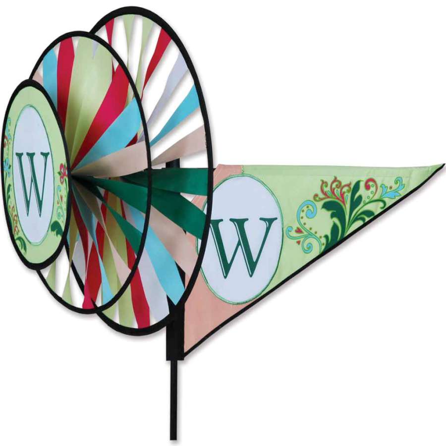 Monogram Triple Spinner with 'W' design rotating in an outdoor garden setting, showcasing vibrant colors and durable SunTex fabric.