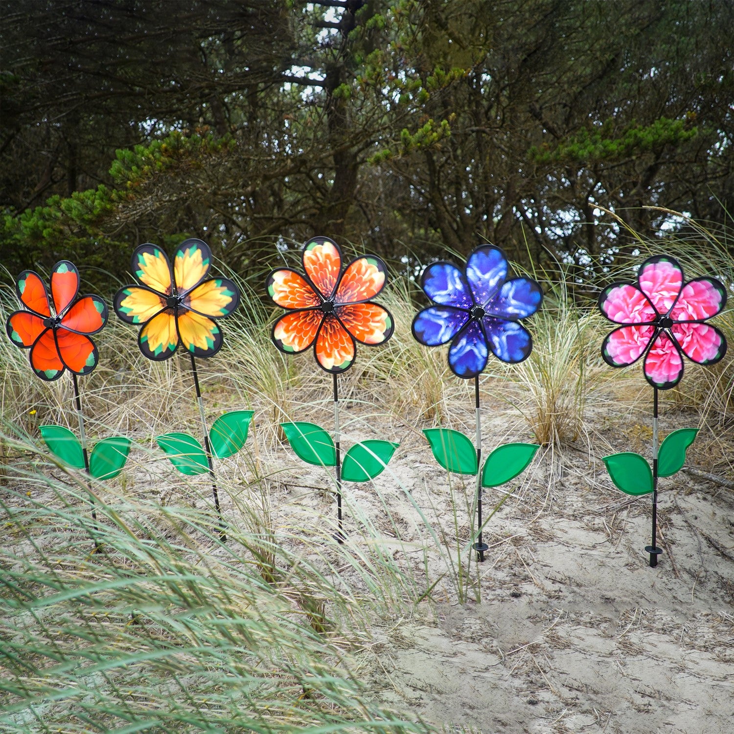 13.5-inch Mum Spinner with Leaves featuring realistic chrysanthemum petals and green leaves, spinning in a garden setting.