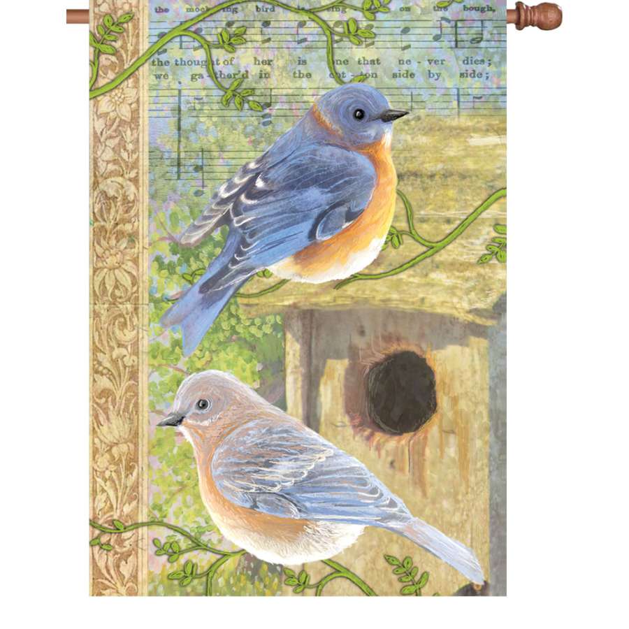 28 in. Musical Bluebirds Flag displaying vibrant bluebirds and musical notes, illuminated in bright colors, fluttering on a flagpole in a garden.