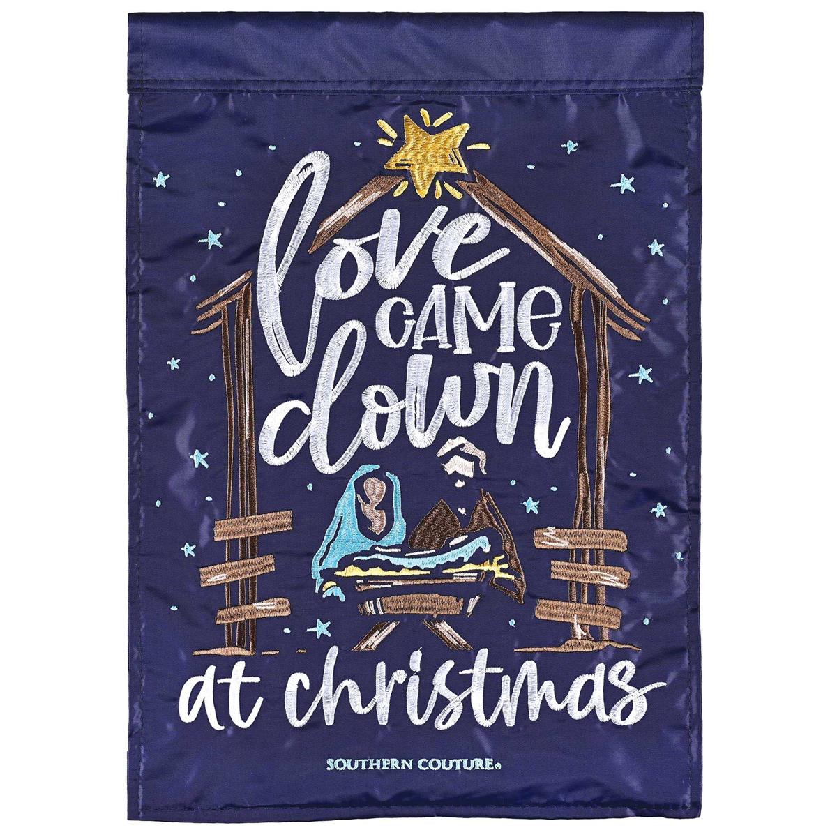 Nativity Love Came Down 13x18 garden flag featuring intricate appliques and embroidery, displayed in an outdoor garden setting.