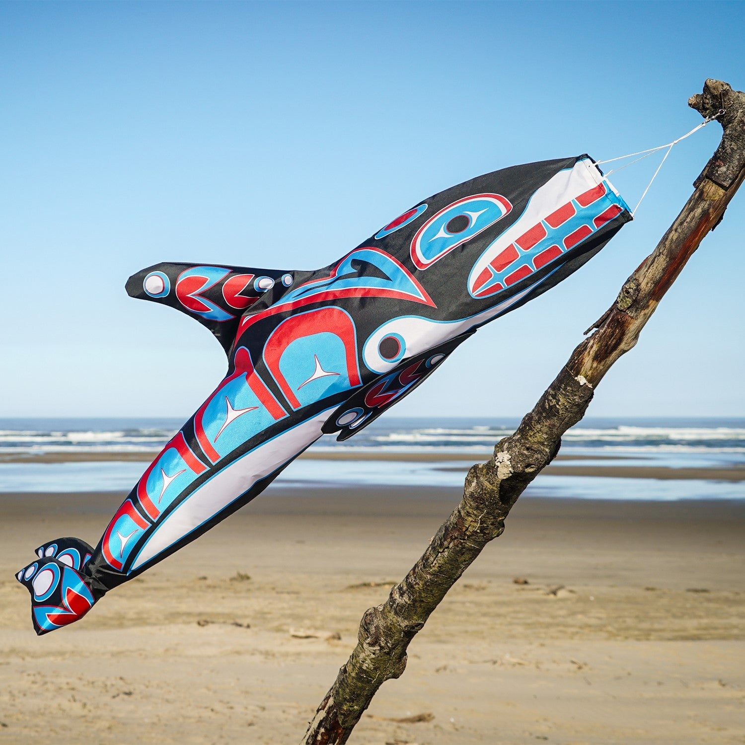 Orca Totem 48" Fish Windsock featuring intricate indigenous design, displayed in an outdoor setting, moving with the breeze.
