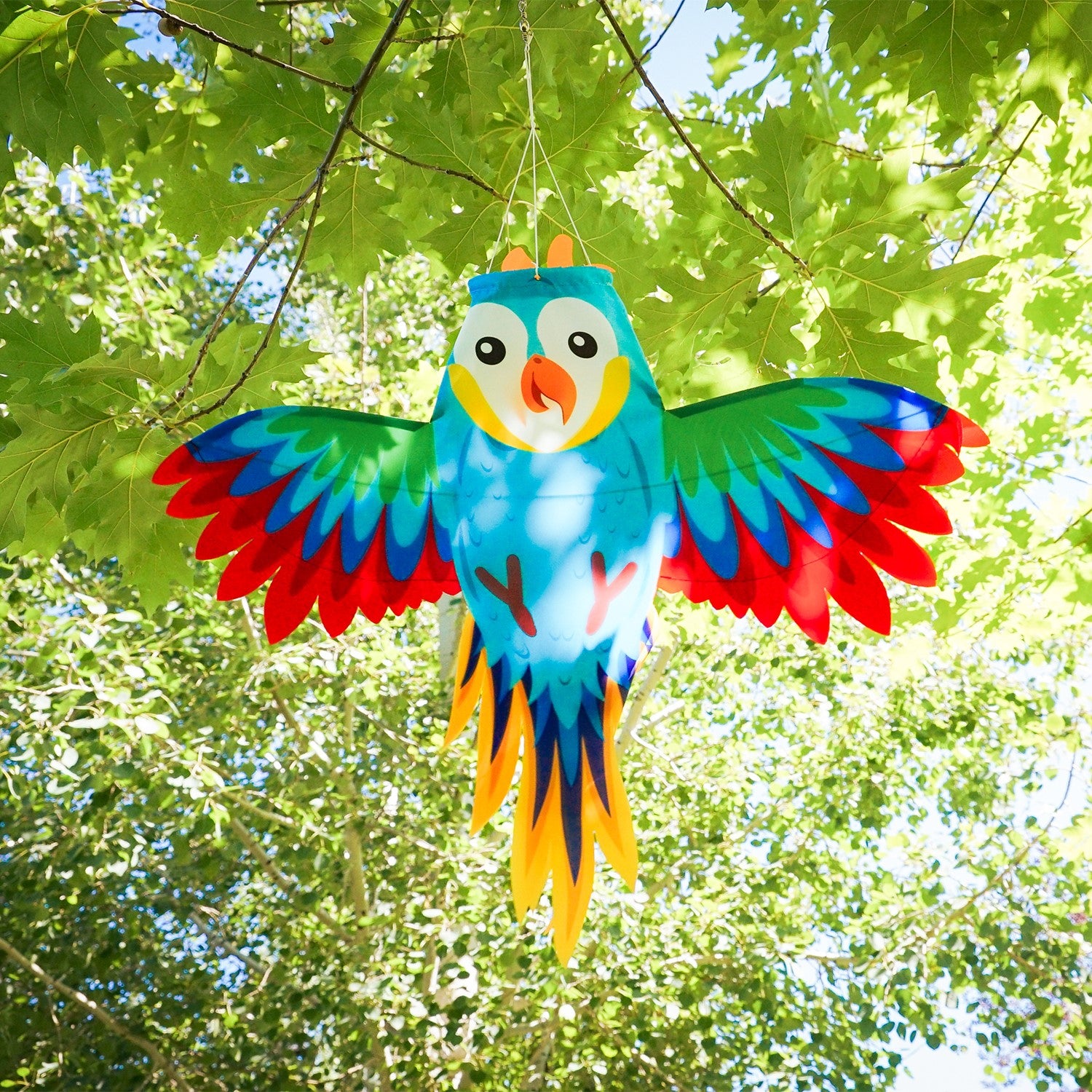 Colorful Parrot Windsock with outstretched wings gracefully hanging outdoors, bringing vibrancy to the garden decor.