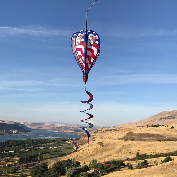 Patriot Eagle Hot Air Balloon kinetic spinner featuring a regal bald eagle against an American flag, displayed in a garden setting.