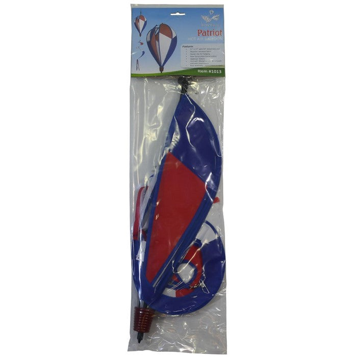 Vibrant Patriot Hot Air Balloon spinner in red, white, and blue colors gently spinning in an outdoor garden setting, showcasing its applique design.