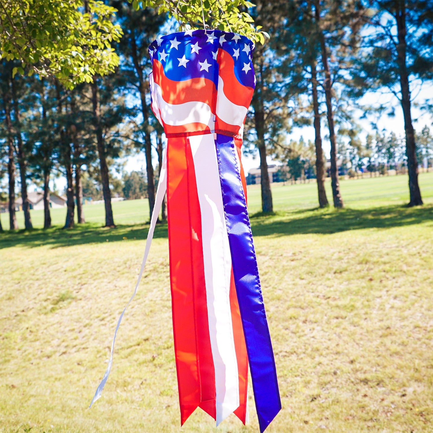 Patriotic Spinning Windsock featuring red, white, and blue stars and stripes design spinning in the outdoor breeze, adding vibrancy to the yard.