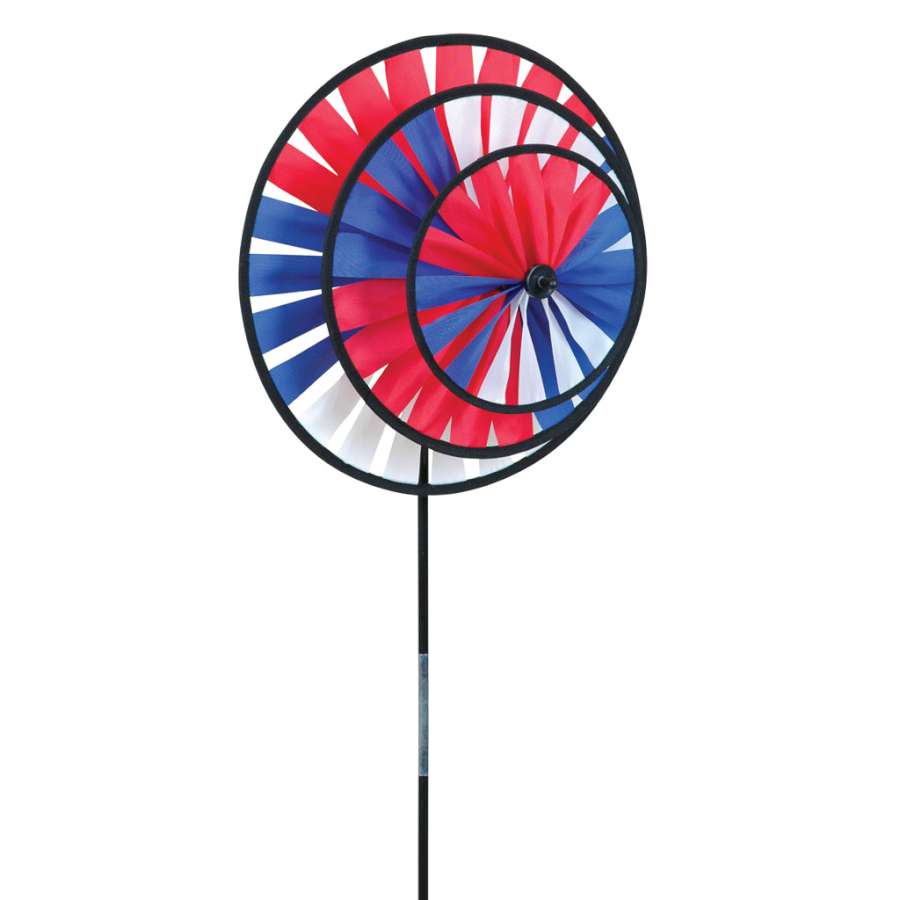 Patriotic Triple Wheel Spinner in vibrant red, white, and blue spinning gently in a garden, showcasing its festive colors and dynamic motion.