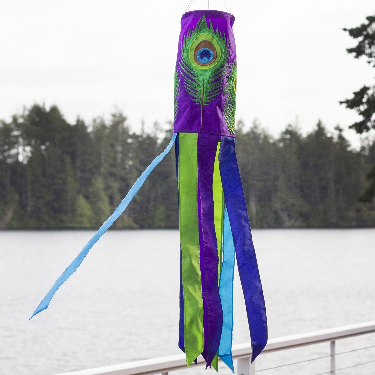 Peacock Feather 40-inch windsock showcasing vibrant appliqued design and dancing tails fluttering in the breeze, enhancing outdoor decor.