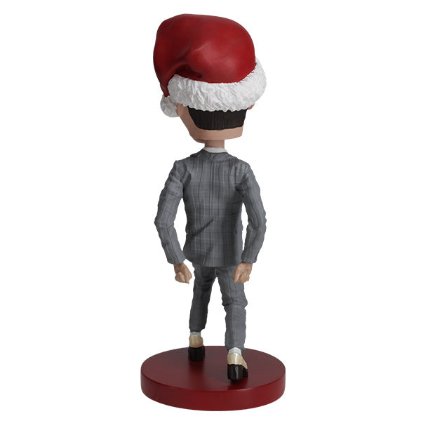 Pee-Wee Herman Holiday Bobblehead featuring the character in a gray suit and red bowtie, standing approximately 7 inches tall on a display surface.