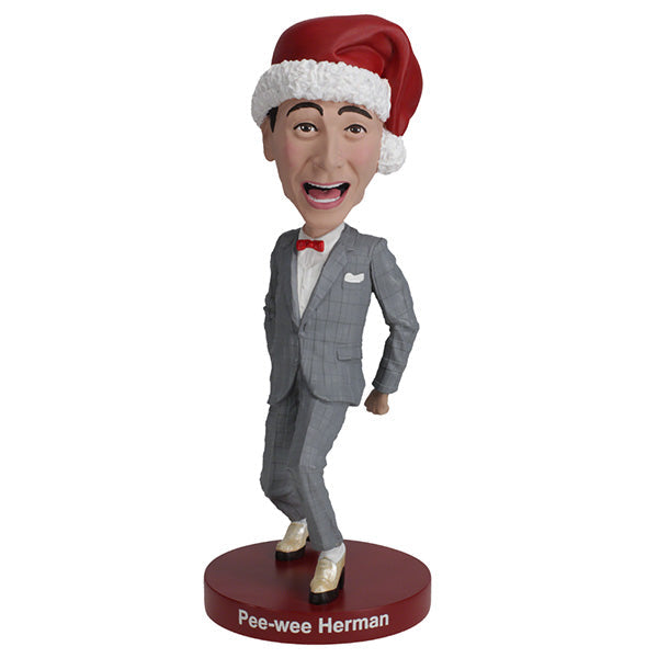 Pee-Wee Herman Holiday Bobblehead featuring the character in a gray suit and red bowtie, standing approximately 7 inches tall on a display surface.