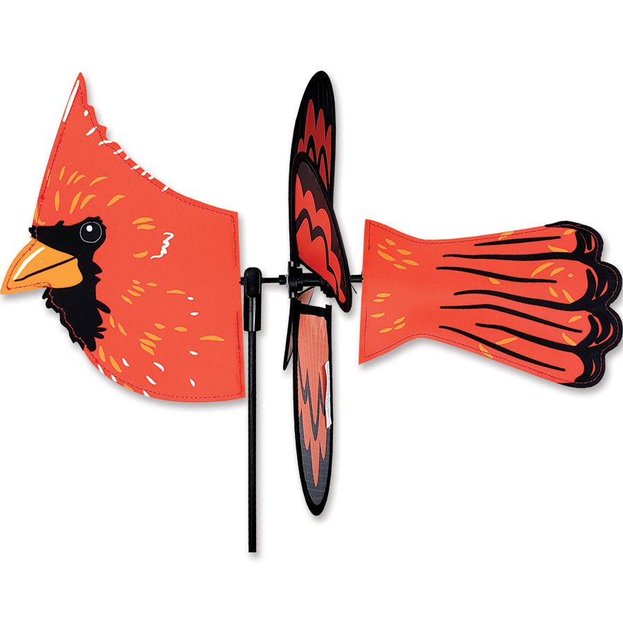 Petite Spinner - Flying Cardinal displayed in a garden, showcasing its vibrant colors and pre-glued wings, spinning peacefully in the breeze.